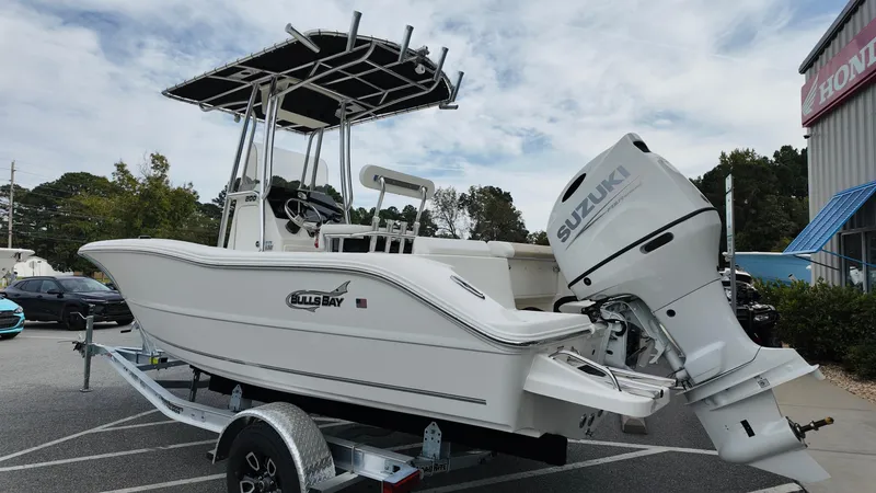 Slide: The Image of 2025 Bulls Bay 200CC boat with Suzuki engine on trailer, parked outdoors. - 5