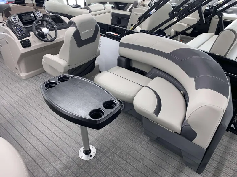 Slide: The Image of 2025 Sylvan L1 LZ boat interior with steering console, seating, and table. - 5