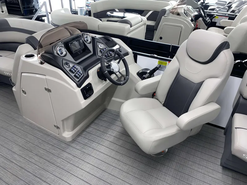 Slide: The Image of 2025 Sylvan L1 LZ boat interior with modern helm and comfortable captain's chair. - 7