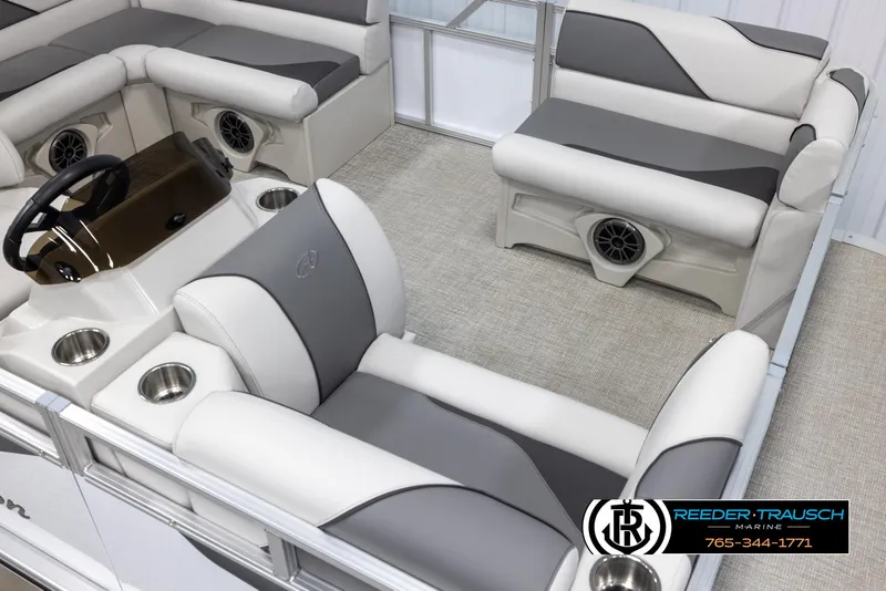 Slide: The Image of 2025 Avalon VENT CR boat interior with gray and white seating, cup holders, and steering console. - 10