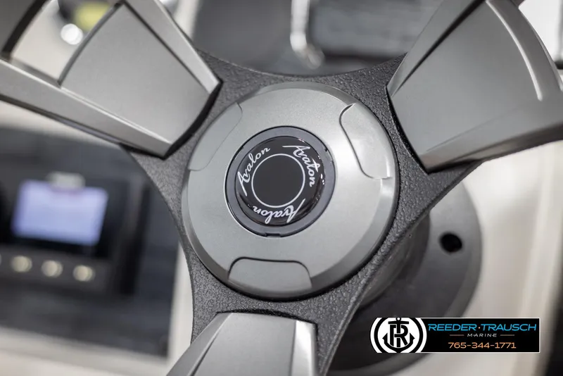 Slide: The Image of Close-up of 2025 Avalon VENT CR steering wheel with logo, Reeder-Trausch branding visible. - 24