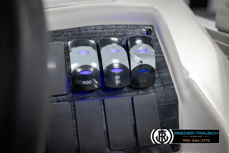 Slide: The Image of Control panel of 2025 Avalon VENT CR boat with radio, navigation, and horn switches. - 28