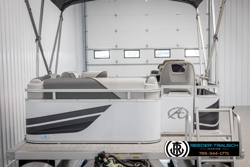 Slide: The Image of 2025 Avalon VENT CR pontoon boat in a garage, featuring sleek design and comfortable seating. - 8