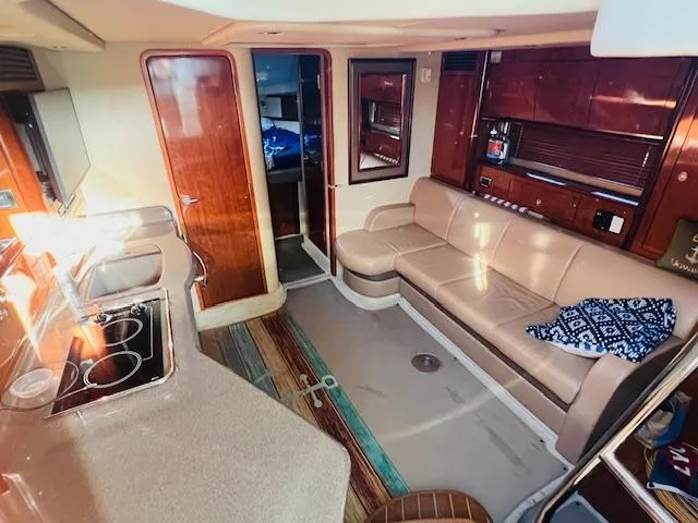 Slide: The Image of Interior of 2004 Sea Ray 390 Sundancer yacht with kitchen and seating area. - 15