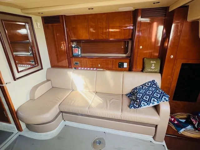Slide: The Image of Luxurious interior of 2004 Sea Ray 390 Sundancer with leather sofa and wooden cabinetry. - 16