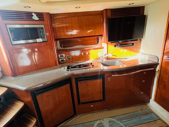 Slide: The Image of Luxurious 2004 Sea Ray 390 Sundancer yacht kitchen with modern appliances and wood cabinetry. - 17