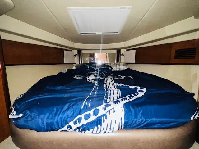 Slide: The Image of Cozy cabin interior of 2004 Sea Ray 390 Sundancer with nautical bedding. - 18