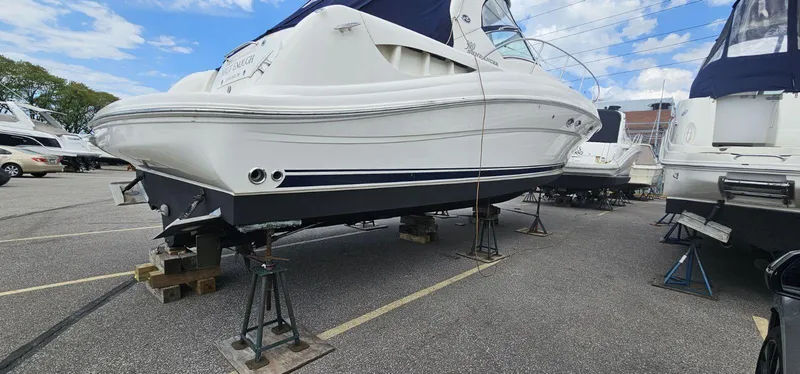 Slide: The Image of 2004 Sea Ray 390 Sundancer yacht on stands in a marina parking lot. - 2
