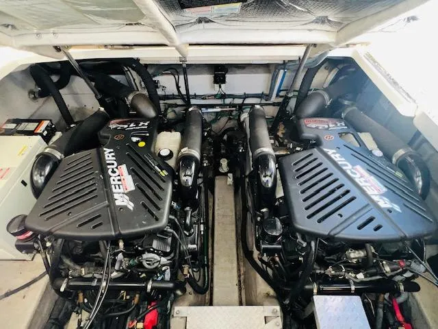 Slide: The Image of 2004 Sea Ray 390 Sundancer engine compartment with twin Mercury engines. - 22