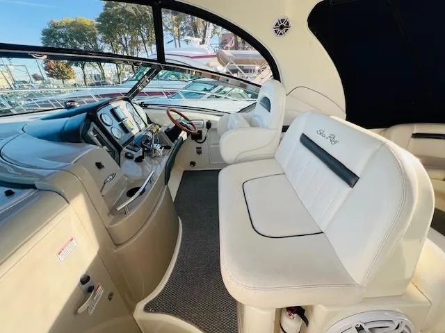 Slide: The Image of Interior of 2004 Sea Ray 390 Sundancer yacht with plush seating and modern dashboard. - 9
