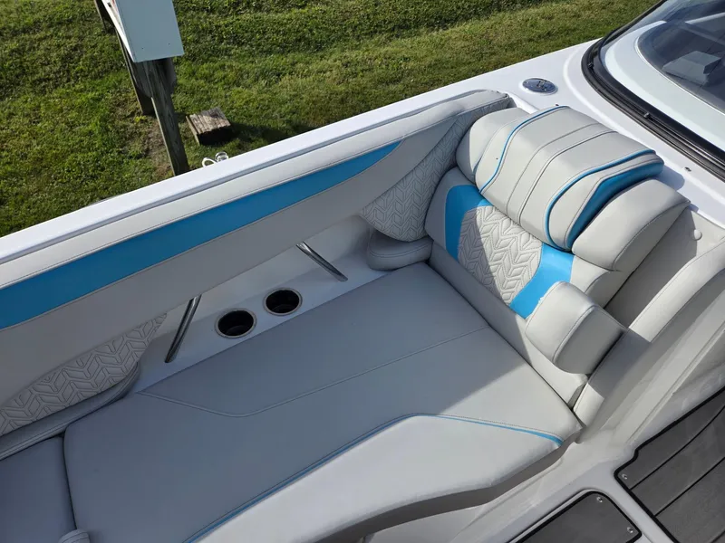 Slide: The Image of 2025 Hurricane SunDeck 2600 OB boat interior with blue and gray seating. - 11