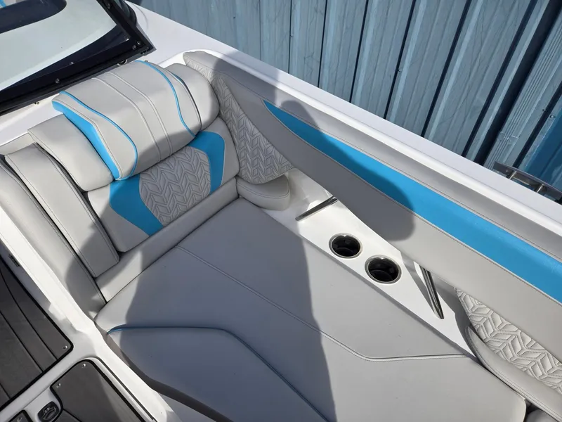 Slide: The Image of 2025 Hurricane SunDeck 2600 OB boat interior with blue and gray seating, cup holders. - 12