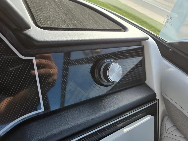 Slide: The Image of 2025 Hurricane SunDeck 2600 OB dashboard with sleek black panel and control knob. - 20