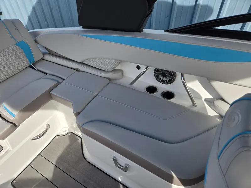Slide: The Image of 2025 Hurricane SunDeck 2600 OB interior with gray and blue seating, cup holders, and speaker. - 28