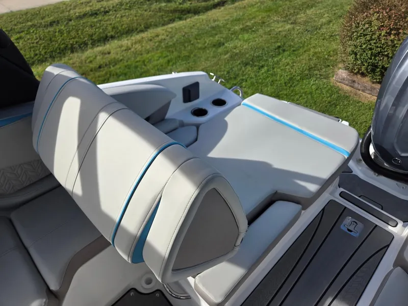 Slide: The Image of 2025 Hurricane SunDeck 2600 OB boat seating area with cup holders and sleek design. - 29