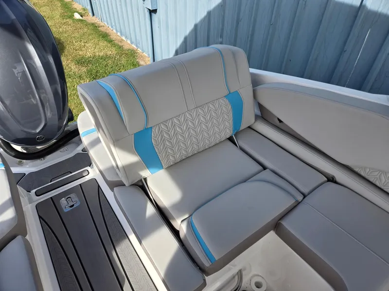 Slide: The Image of 2025 Hurricane SunDeck 2600 OB boat seating with gray and blue upholstery. - 30