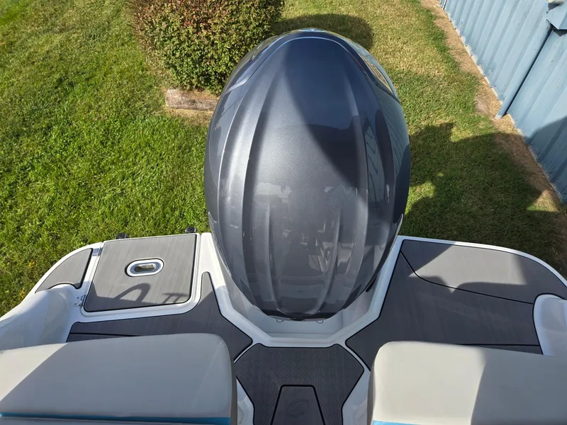 Slide: The Image of 2025 Hurricane SunDeck 2600 OB boat engine, top view, on grassy background. - 31