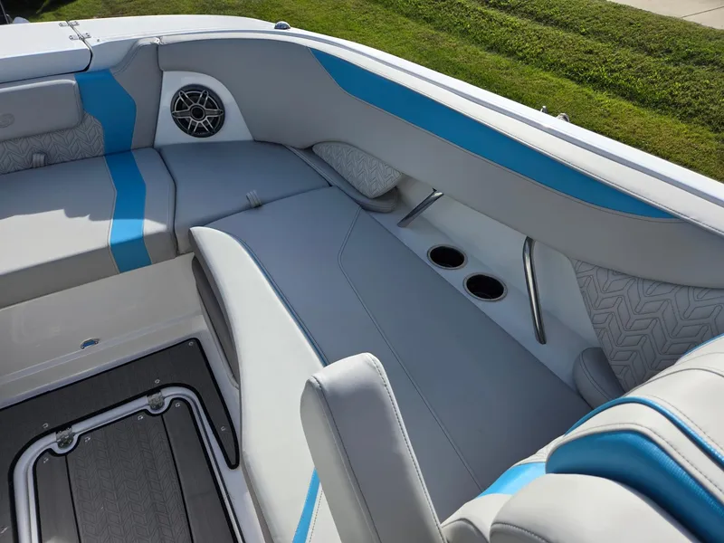 Slide: The Image of 2025 Hurricane SunDeck 2600 OB boat interior with blue accents and seating. - 40