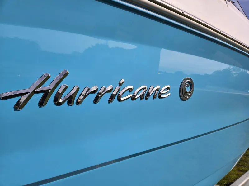 Slide: The Image of 2025 Hurricane SunDeck 2600 OB boat with blue exterior and chrome logo. - 42