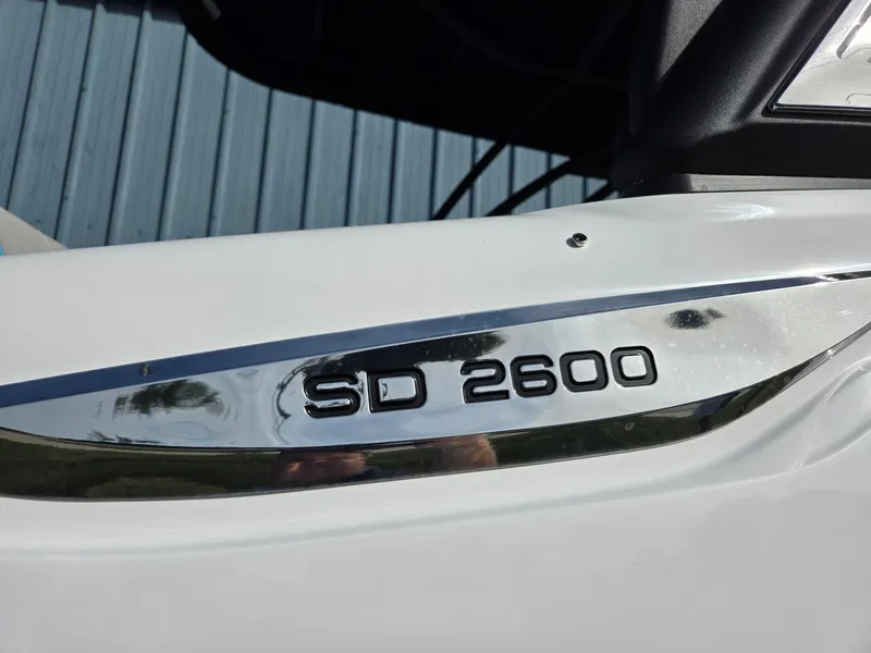 Slide: The Image of 2025 Hurricane SunDeck 2600 OB boat emblem close-up. - 43