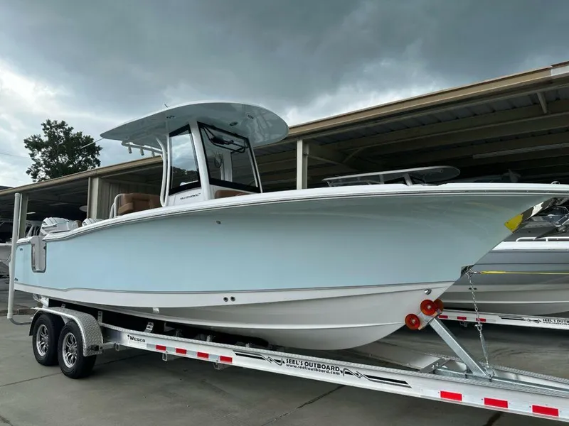 The Image of 2025 Sea Hunt Ultra 265 SE boat on trailer under cloudy sky. - 0