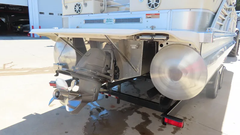 Slide: The Image of 2013 Bennington 2875 QCW I/O pontoon boat rear view with outboard motor and trailer. - 10