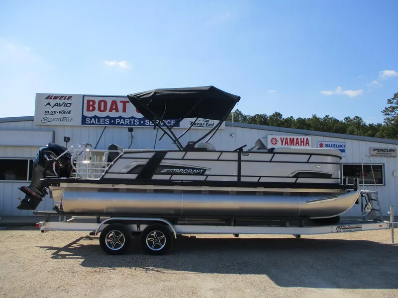 Slide: The Image of 2025 Starcraft EXS-3DL pontoon boat on trailer outside dealership. - 19