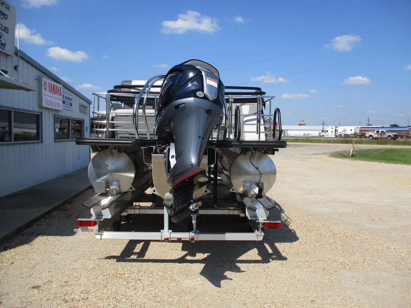 Slide: The Image of 2025 Starcraft EXS-3DL pontoon boat with outboard motor on trailer. - 2