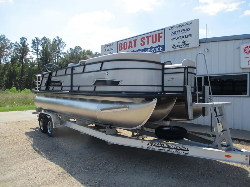 Slide: The Image of 2025 Starcraft EXS-3DL pontoon boat on trailer outside dealership. - 5