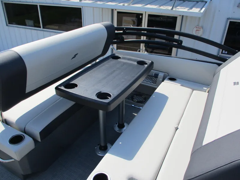 Slide: The Image of Starcraft EXS-3DL 2025 boat interior with seating and table, featuring cup holders. - 9