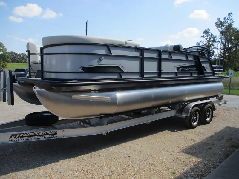 The Image of 2025 Starcraft EXS-3DL pontoon boat on trailer, parked outdoors. - 0