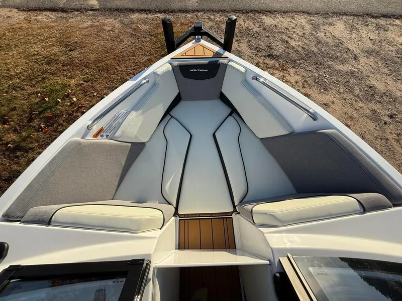 Slide: The Image of 2025 Nautique Ski 200 Open Bow interior with sleek seating and modern design. - 14
