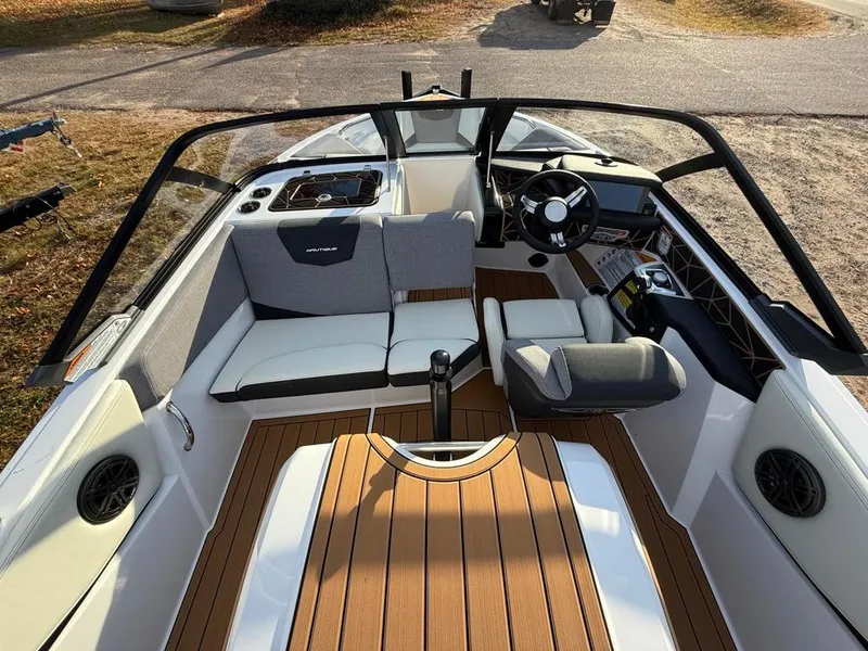 Slide: The Image of 2025 Nautique Ski 200 Open Bow boat interior with modern seating and dashboard. - 18