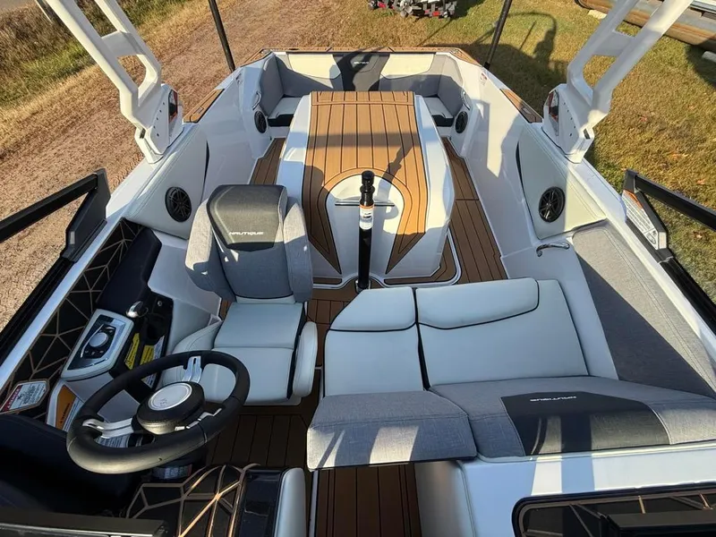 Slide: The Image of 2025 Nautique Ski 200 Open Bow boat interior with modern seating and steering wheel. - 19