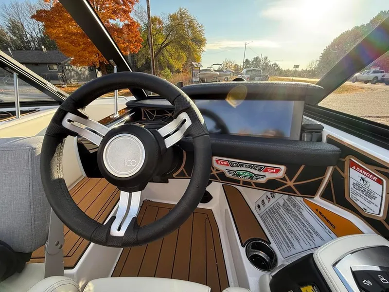 Slide: The Image of 2025 Nautique Ski 200 Open Bow interior with steering wheel and dashboard. - 27