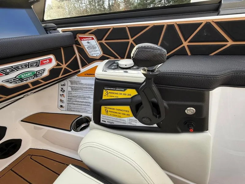 Slide: The Image of 2025 Nautique Ski 200 Open Bow interior controls and dashboard detail. - 29