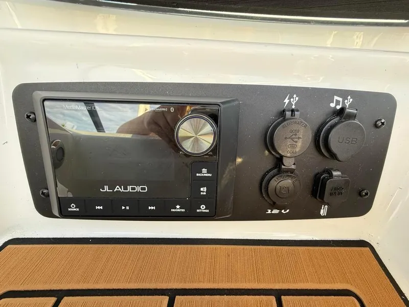 Slide: The Image of JL Audio system on 2025 Nautique Ski 200 Open Bow boat dashboard. - 48