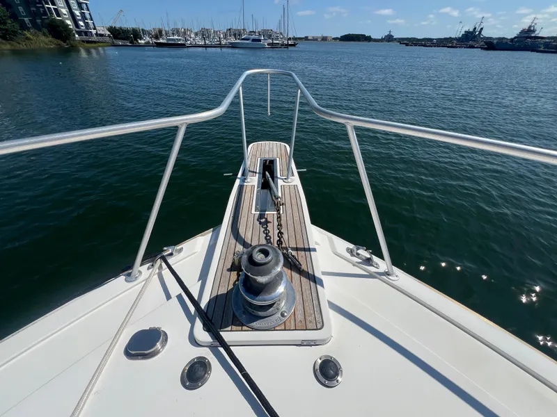 Slide: The Image of Bow view of 1989 Bertram 50 Convertible yacht in a marina setting. - 10