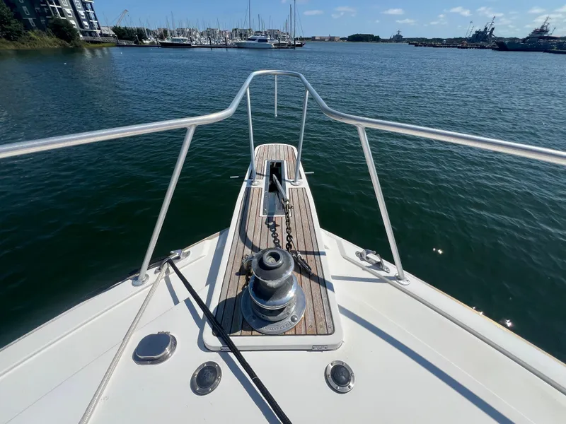 Slide: The Image of Bow view of 1989 Bertram 50 Convertible yacht in a marina. - 11