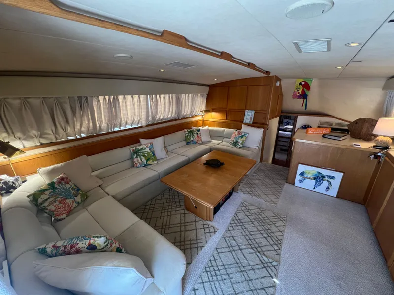Slide: The Image of Interior of 1989 Bertram 50 Convertible yacht with cozy seating and nautical decor. - 14