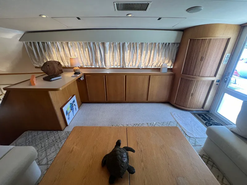 Slide: The Image of Interior of 1989 Bertram 50 Convertible yacht with elegant wood furnishings. - 19