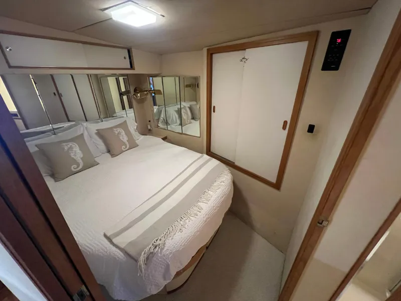 Slide: The Image of Cozy bedroom in 1989 Bertram 50 Convertible yacht with seahorse-themed pillows. - 24