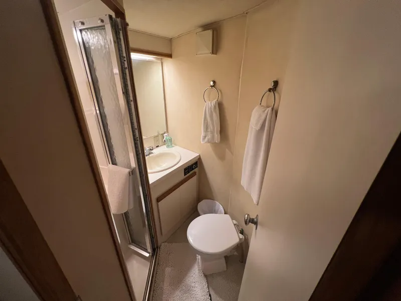 Slide: The Image of Compact bathroom in 1989 Bertram 50 Convertible yacht with shower, sink, and toilet. - 26