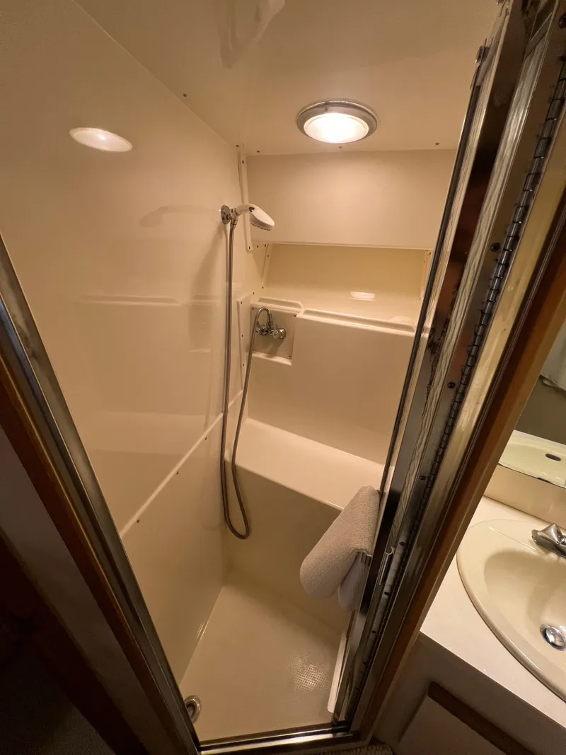 Slide: The Image of Compact bathroom with shower in 1989 Bertram 50 Convertible yacht. - 27