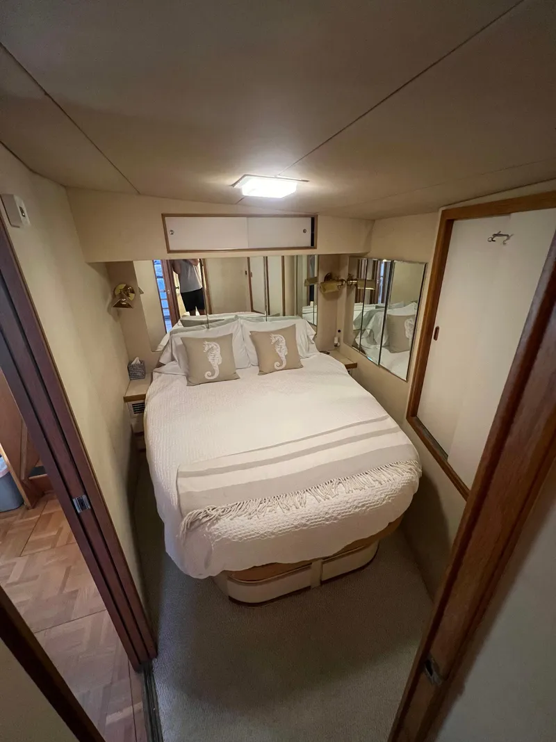 Slide: The Image of Cozy bedroom interior of 1989 Bertram 50 Convertible yacht with elegant bedding. - 29