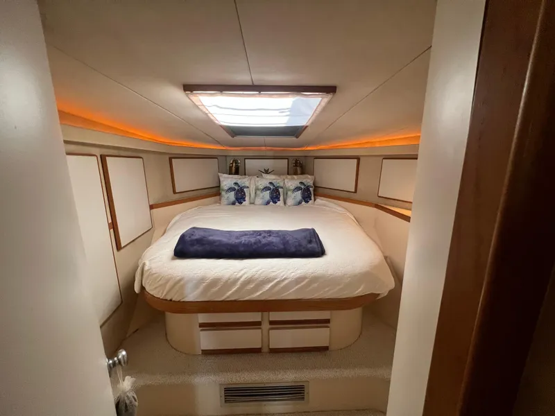 Slide: The Image of Cozy bedroom in 1989 Bertram 50 Convertible yacht with skylight and plush bedding. - 32
