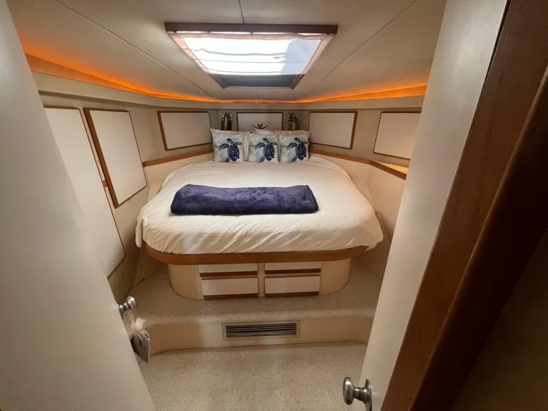 Slide: The Image of Cozy bedroom in 1989 Bertram 50 Convertible yacht with skylight and elegant decor. - 33
