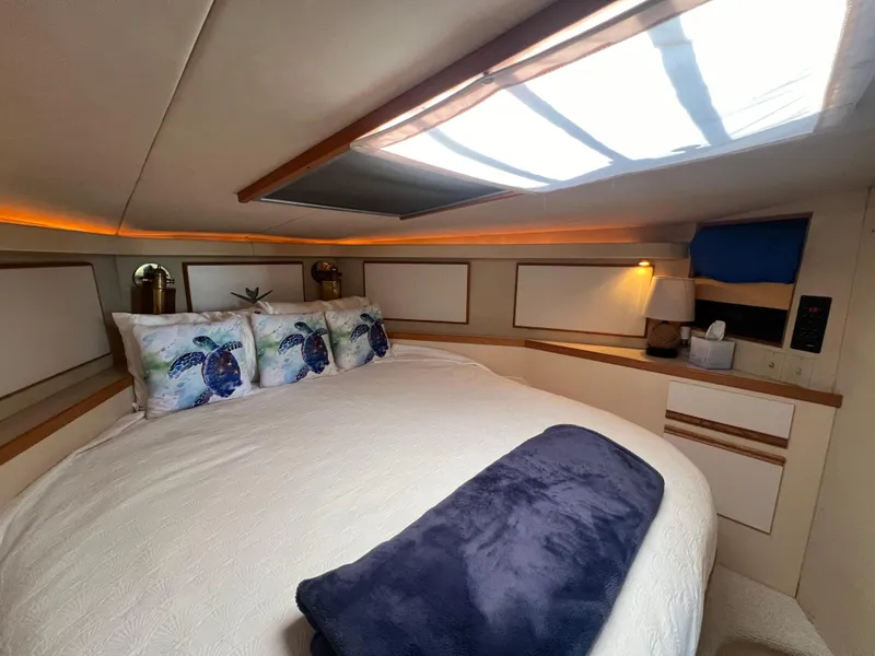 Slide: The Image of Cozy bedroom in 1989 Bertram 50 Convertible yacht with nautical decor and skylight. - 35