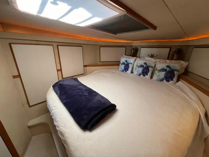 Slide: The Image of Cozy bedroom in 1989 Bertram 50 Convertible yacht with turtle-themed pillows. - 36
