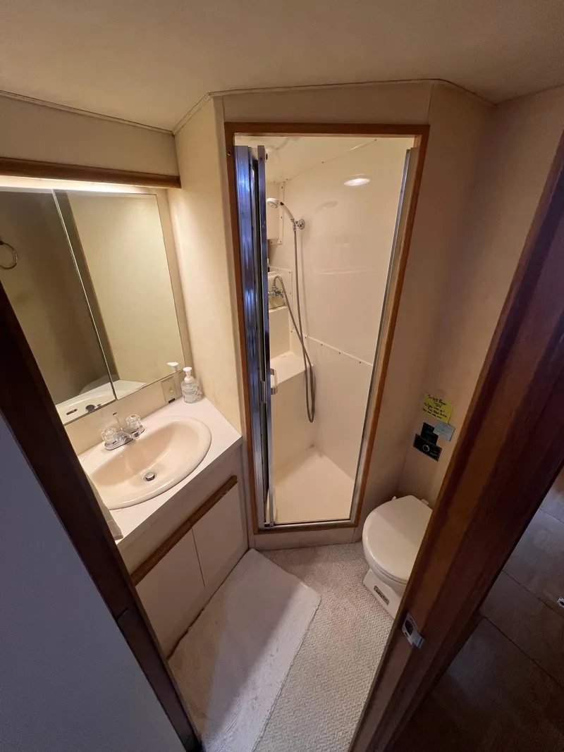 Slide: The Image of 1989 Bertram 50 Convertible yacht bathroom with shower, sink, and toilet. - 37